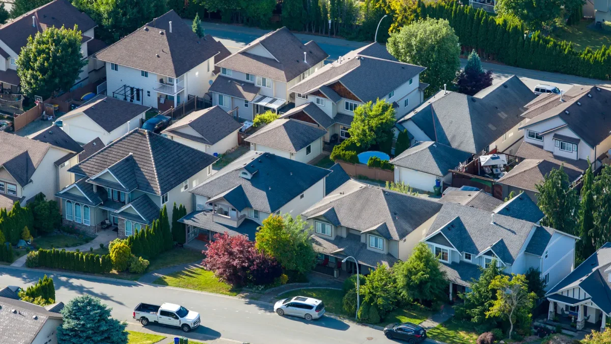 Aerial view of a tree-lined suburban street with detached homes, illustrating the balancing housing market in Durham Region and the GTA in summer 2026