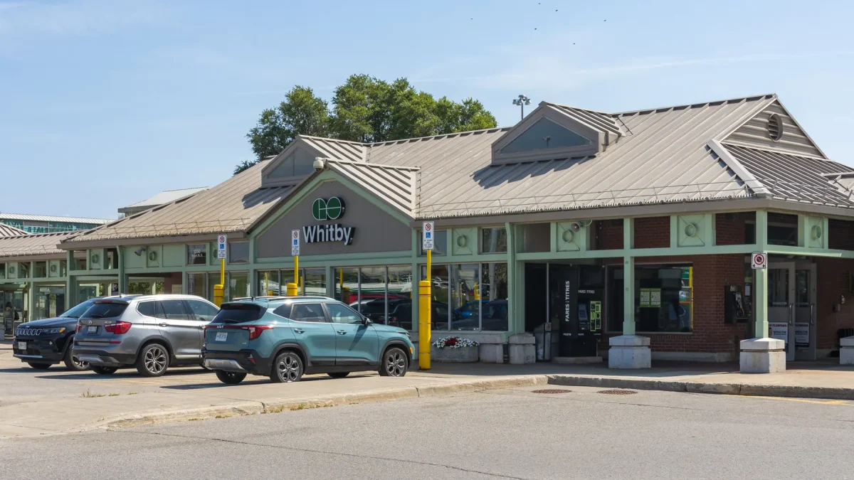 The Whitby GO Station building with the GO Whitby sign and cars parked outside, photographed in August 2026